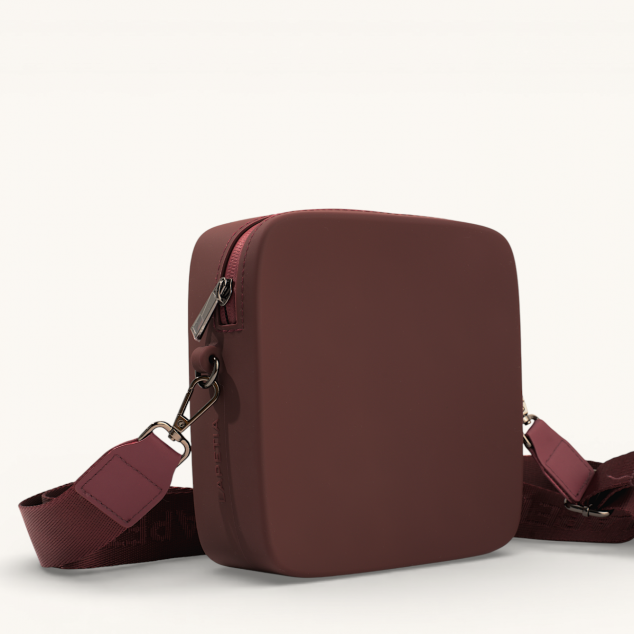 Burgundy Mini Quad silicone bag side view with geometric silhouette